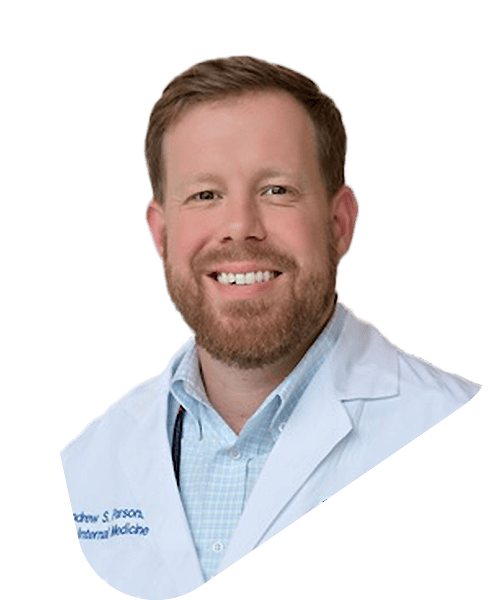 Andrew parsons, a smiling doctor in a white coat.